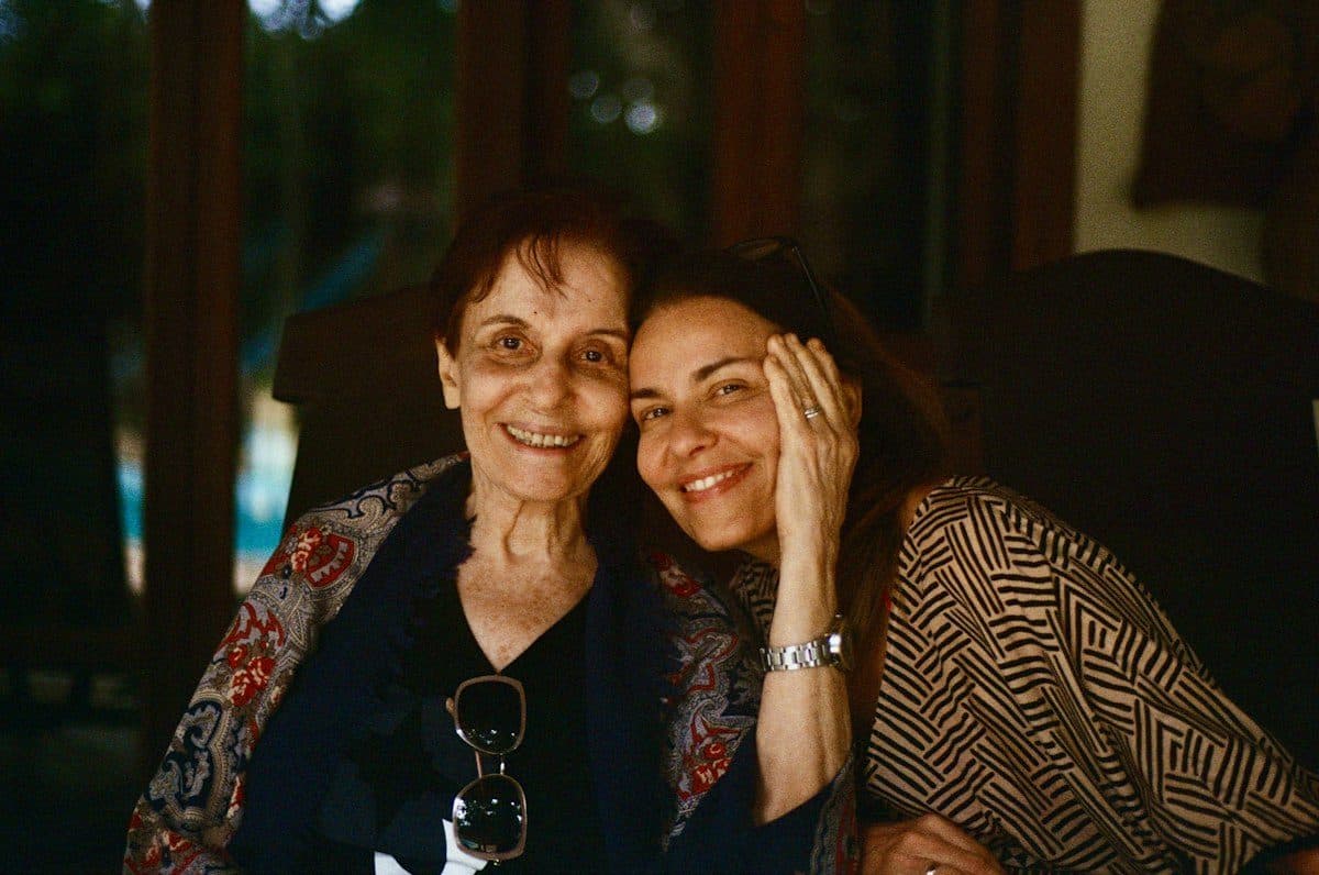 A mother and her adult daughter sharing an embrace